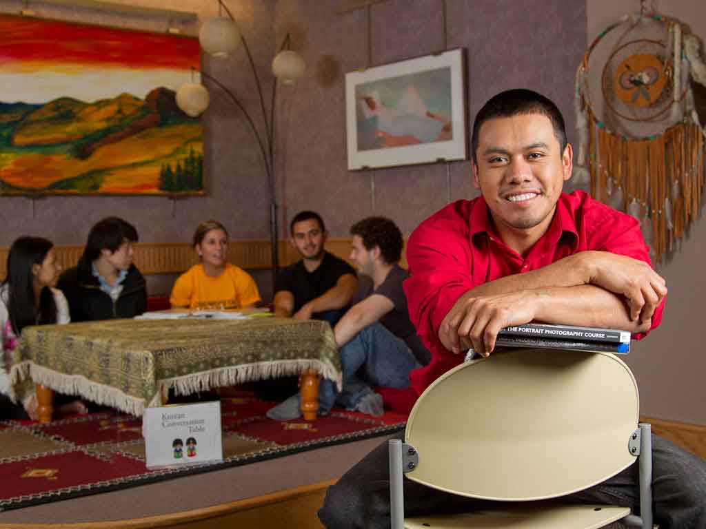 Students sitting around a table in the multicultural center